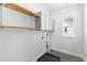 Functional laundry room with overhead cabinets, wooden shelf, and window, making laundry chores more enjoyable at 1213 Captain Rivers Dr, Charleston, SC 29412