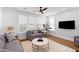 Cozy living room with neutral tones, comfortable seating, and a view through large windows at 1213 Captain Rivers Dr, Charleston, SC 29412