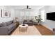 Bright and airy living room featuring comfortable seating, large windows, and neutral decor at 1213 Captain Rivers Dr, Charleston, SC 29412