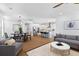 Spacious living room with gray sofas, modern decor, a view of the kitchen, and natural hardwood flooring at 1213 Captain Rivers Dr, Charleston, SC 29412