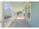 Relaxing covered porch with blue ceiling, white columns, offering outdoor space to enjoy neighborhood views and fresh air at 1213 Captain Rivers Dr, Charleston, SC 29412