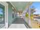 Inviting covered porch with white railings, offering outdoor space to enjoy neighborhood views and fresh air at 1213 Captain Rivers Dr, Charleston, SC 29412