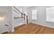 An elegant staircase features hardwood floors, natural lighting, and white trim for a modern design at 1213 Captain Rivers Dr, Charleston, SC 29412