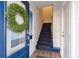 Inviting entryway featuring a blue door, wreath, and staircase to the upper level at 1213 Gatch Ct, Mount Pleasant, SC 29464