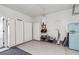 Clean and organized garage with built-in storage cabinets and a modern refrigerator at 1213 Gatch Ct, Mount Pleasant, SC 29464