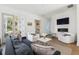 Cozy living room featuring modern decor, a fireplace, and balcony access at 1213 Gatch Ct, Mount Pleasant, SC 29464