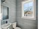 Stylish powder room with textured wallpaper and window for natural light at 1213 Gatch Ct, Mount Pleasant, SC 29464