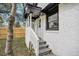 Charming entrance featuring white painted brick, gray stairs, and a classic black trimmed porch roof at 1249 Sumner Ave, North Charleston, SC 29406