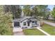 Charming bungalow with a detached garage, fresh white paint, black trim, and inviting front porch at 1249 Sumner Ave, North Charleston, SC 29406