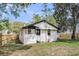 Charming home exterior with white brick, complemented by a fenced yard and lush greenery at 1249 Sumner Ave, North Charleston, SC 29406
