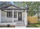 Close up of front porch with charming white columns and railing detail, steps and a decorative front door at 1249 Sumner Ave, North Charleston, SC 29406