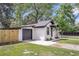 Side view of white brick home with black trim and garage, showcasing a neatly landscaped yard at 1249 Sumner Ave, North Charleston, SC 29406