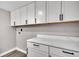 Bright laundry room features white cabinets and marble countertops at 1249 Sumner Ave, North Charleston, SC 29406