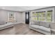 Living room featuring new flooring, large windows, and neutral paint at 1249 Sumner Ave, North Charleston, SC 29406