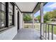 Covered porch area with classic white columns, gray flooring and black trim, providing an inviting outdoor space at 1249 Sumner Ave, North Charleston, SC 29406