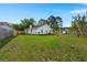 A spacious backyard with a fence and a storage shed, surrounded by green grass and trees to complete the home at 1306 Markley Ct, Moncks Corner, SC 29461