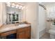 A bathroom featuring a wooden vanity with a sink, a toilet, and a shower-tub with a white curtain at 1306 Markley Ct, Moncks Corner, SC 29461