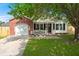 Charming single-story home featuring a brick facade and a cozy front porch, framed by mature trees and landscaping at 1306 Markley Ct, Moncks Corner, SC 29461