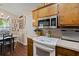 A quaint kitchen with a view to the front yard with updated appliances, lots of cabinet space and wood floors at 1306 Markley Ct, Moncks Corner, SC 29461