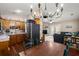 An open kitchen with stainless steel appliances leads to the living room and dining area in this well-lit home at 1306 Markley Ct, Moncks Corner, SC 29461