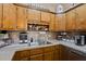 This kitchen showcases wood cabinetry, a stainless steel sink, and modern appliances for everyday cooking convenience at 1306 Markley Ct, Moncks Corner, SC 29461