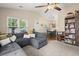 Open-concept living area showcasing a large sectional, dining space, and ample natural light from surrounding windows at 1306 Markley Ct, Moncks Corner, SC 29461
