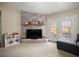 Cozy living room with a brick fireplace, French doors, comfortable seating, and shelving for storage and display at 1306 Markley Ct, Moncks Corner, SC 29461
