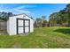 Backyard featuring a white shed with a black door and a grassy lawn at 1306 Markley Ct, Moncks Corner, SC 29461