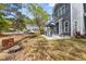 Spacious backyard with a metal table and chairs under a blue umbrella, near a hammock and nice lawn at 135 Marshside Dr, Summerville, SC 29485