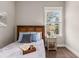 Cozy bedroom with two windows and neutral walls filled with a wooden frame bed and side table at 135 Marshside Dr, Summerville, SC 29485