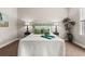 Bedroom with decorative lamps, blue and green pillows, and bed covered with a white quilt at 135 Marshside Dr, Summerville, SC 29485