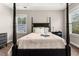 This spacious bedroom features a four-poster bed and neutral decor at 135 Marshside Dr, Summerville, SC 29485