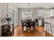 Bright dining area features hardwood floors, a dark wood table, and natural light at 135 Marshside Dr, Summerville, SC 29485