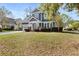 Inviting two-story home with lush landscaping, a well-kept lawn, and an attached garage at 135 Marshside Dr, Summerville, SC 29485
