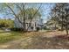 Charming house with a well-kept lawn, a patio set, and plenty of shade trees at 135 Marshside Dr, Summerville, SC 29485