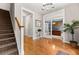 Spacious foyer featuring hardwood floors, a staircase, and an open view to an office through glass doors at 135 Marshside Dr, Summerville, SC 29485