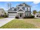Beautiful two-story home featuring a well-maintained lawn, attached garage, and welcoming front entrance at 135 Marshside Dr, Summerville, SC 29485