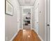 Hallway with hardwood floors leading to the living room, showcasing neutral walls and white trim at 135 Marshside Dr, Summerville, SC 29485