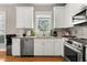 Functional kitchen with white cabinets, stainless appliances, and stylish backsplash at 135 Marshside Dr, Summerville, SC 29485
