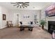 Bright living room featuring a cozy fireplace, neutral decor, and ample natural light at 135 Marshside Dr, Summerville, SC 29485