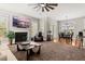 Open-concept living area with a fireplace, large windows, and a dining area adjacent to the living space at 135 Marshside Dr, Summerville, SC 29485
