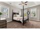 Spacious main bedroom with four-poster bed, large windows, and plush carpet at 135 Marshside Dr, Summerville, SC 29485