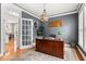 Elegant office with a large wooden desk, a patterned rug, a decorative light fixture, and a view of the hallway at 135 Marshside Dr, Summerville, SC 29485