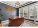 Well-lit office space featuring a large desk, window blinds, and an elegant light fixture at 135 Marshside Dr, Summerville, SC 29485