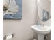Charming powder room with pedestal sink, decorative mirror, and soft lighting at 135 Marshside Dr, Summerville, SC 29485