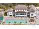 Breathtaking aerial view showcasing an estate with a pool and lounge area nestled by the water at 1466 Mizzen Aly, Johns Island, SC 29455