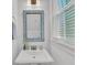 Stylish powder room featuring a vessel sink, a modern faucet, and a decorative mirror at 1466 Mizzen Aly, Johns Island, SC 29455
