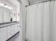 Well-lit bathroom featuring a granite countertop, white cabinetry, and a shower with a white curtain at 1466 Mizzen Aly, Johns Island, SC 29455