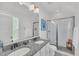 Bright bathroom with double sinks, granite countertop, glass shower, and white cabinets at 1466 Mizzen Aly, Johns Island, SC 29455