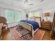Sunny primary bedroom featuring hardwood floors, bright windows, and a comfortable mattress at 1466 Mizzen Aly, Johns Island, SC 29455